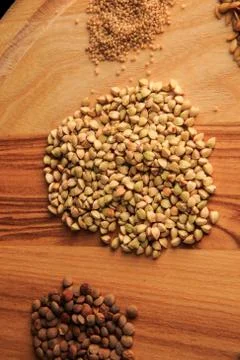 Vertical view macro on board with assorted groat handfuls 写真素材