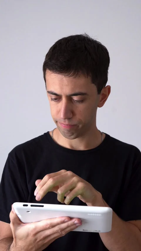 Vertical View Of A Man Holding iPod Having Problem About Technology. Medium 스톡 동영상 304940656