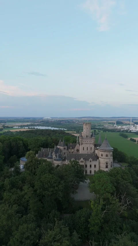 Vertical view of Marienburg Castle on its forested hill above fields Video stock 340160098