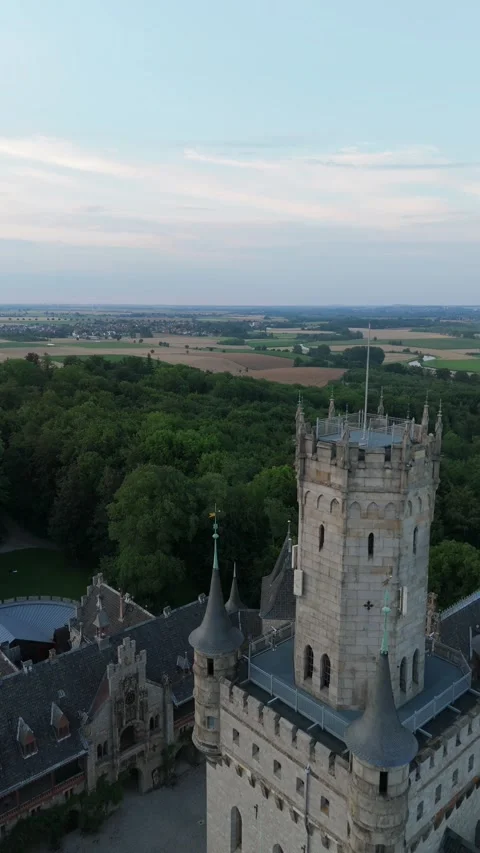 Vertical view of Marienburg Castle tower above the forest Stockbeeldmateriaal 340160016