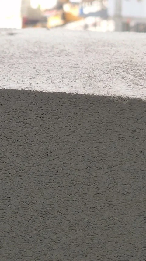 Vertical View of Mason Leveling Aerated Concrete Wall Stockbeeldmateriaal 334334873