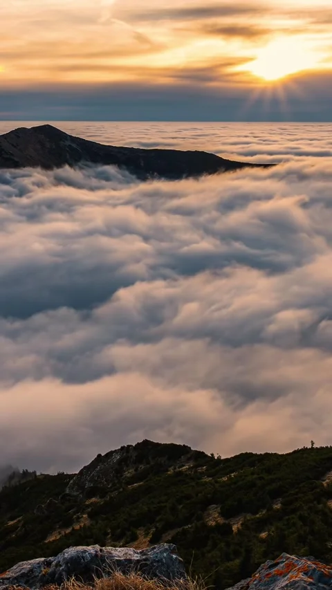 Vertical view of misty clouds motion fast in alps mountains valley Stock Footage 295344790
