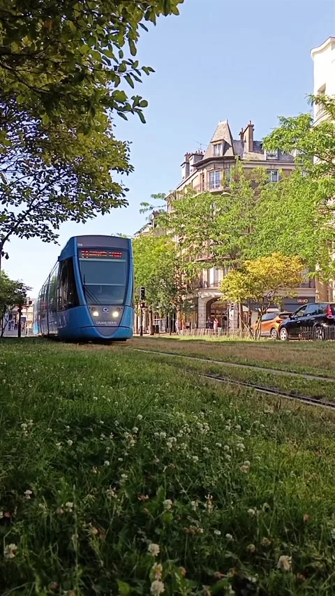 Vertical view of a modern blue tram operating on green tracks in Reims, France Stock Footage 339982306