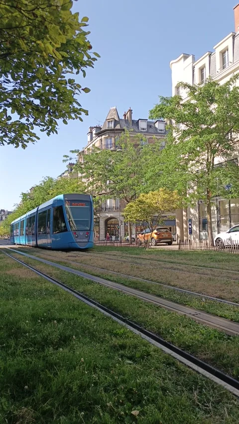 Vertical view of a modern blue tram operating on green tracks Stock Footage 339982648