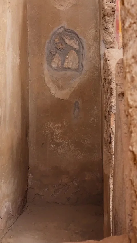 Vertical view of a narrow Pompeii interior wall with faded plaster, a small Stock Footage 336225099
