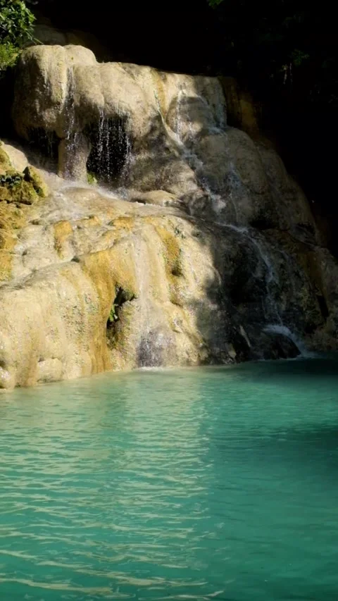 Vertical view of a natural waterfall pool in turquoise green Stock Footage 321321210