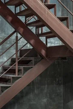Vertical view of Old metal steps with handrails against concrete wall backg.. Stock Photos