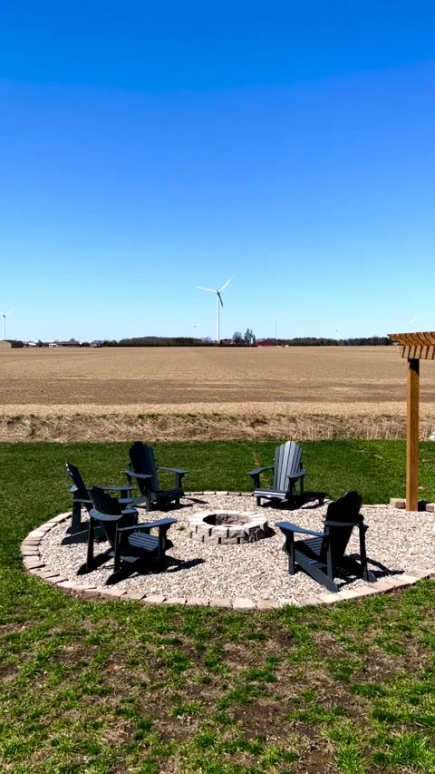 Vertical view of outdoor resting place with wind turbines in the back Stock Footage 238490028