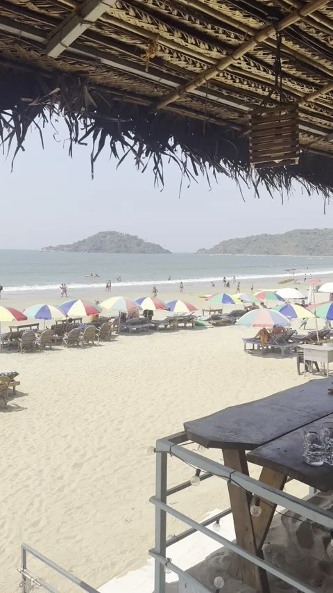 Vertical view of Palolem Beach through beach shack canopy with ocean view Goa Видео 343133939