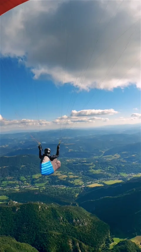 Vertical view of Paragliding Flight Above Green Mountains, Calm Aerial Adventure Stock Footage 310668269