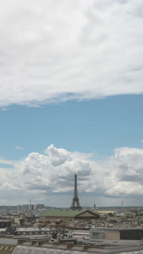 Vertical View of Paris Skyline with Eiffel Tower and City Rooftops under Blue Sk Stock Footage 337052396