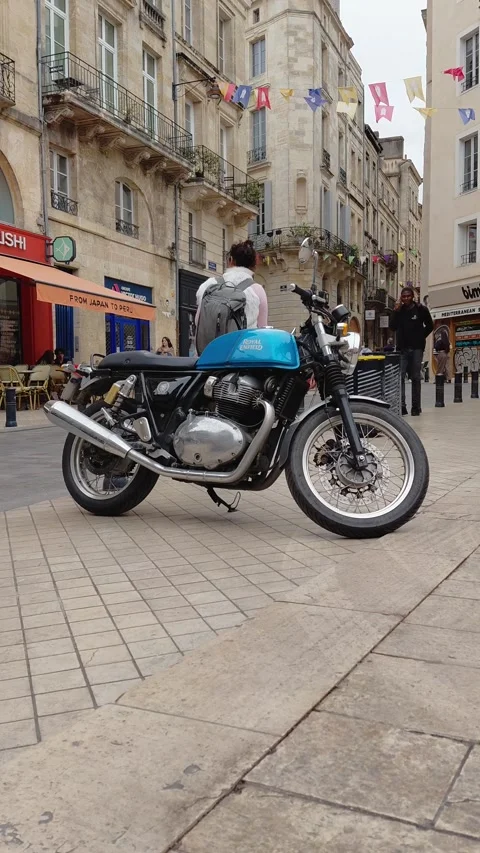 Vertical view of a parked blue modern classic motorcycle on a city street i.. Stock Footage 348028716