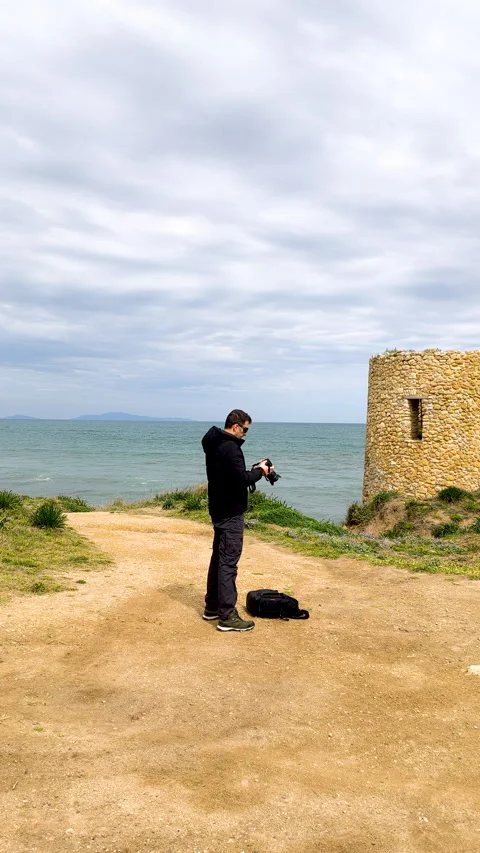 Vertical view of a photographer checking the camera after a shot Stock Footage 332722974