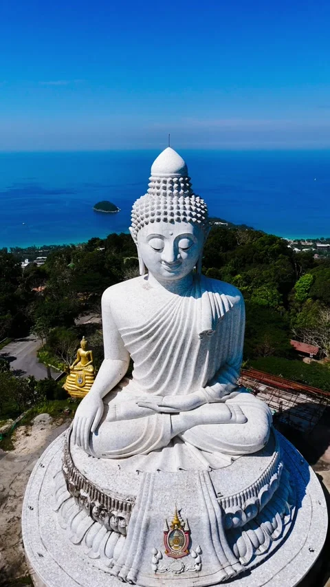 Vertical view of Phuket Big Buddha with sea in background – Thailand – 4K Stock Footage 325079024