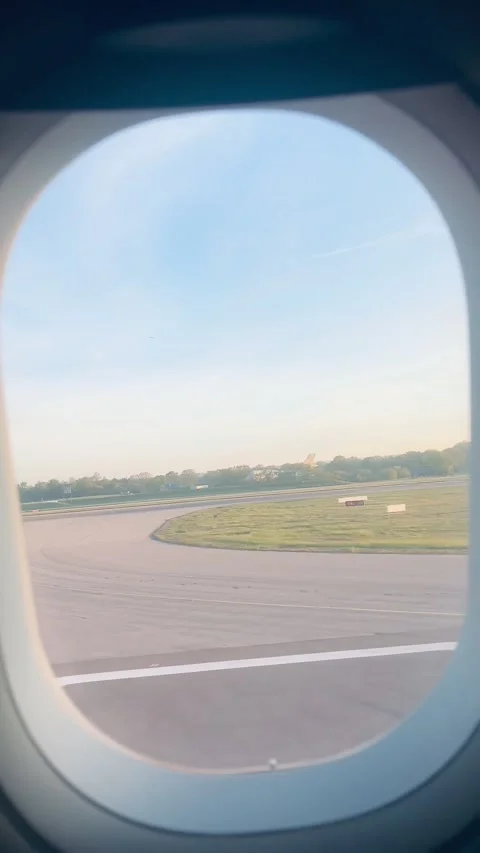 Vertical View: Plane Takeoff From Window Seat on Runway at Sunrise – Social Stock Footage 346750403