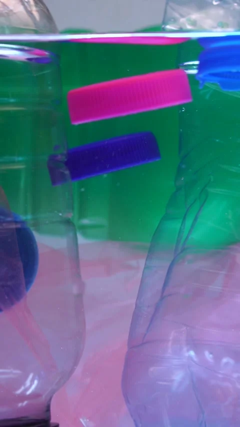 Vertical View, Plastic Waste in Water, Bottles, Caps and Bags, Close Up Stock Footage 292947586