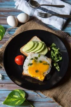 Vertical view of poached eggs with bacon and vegetables Stock Photos