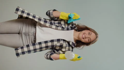 Vertical View.A Portrait of a Happy Young Woman with Rag and Cleaning Products. Stock Footage 249431569