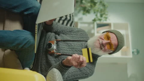 Vertical View.A Portrait of an Old Man Traveler With a Credit Card. Stock Footage 244960778