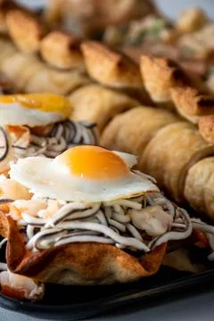 Vertical view of puff pastry with gluttony, quail egg and prawns with unfocus Stock Photos