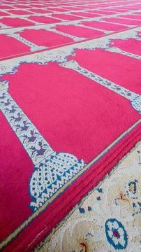 Vertical view of red patterned mosque prayer carpet Stock Photos