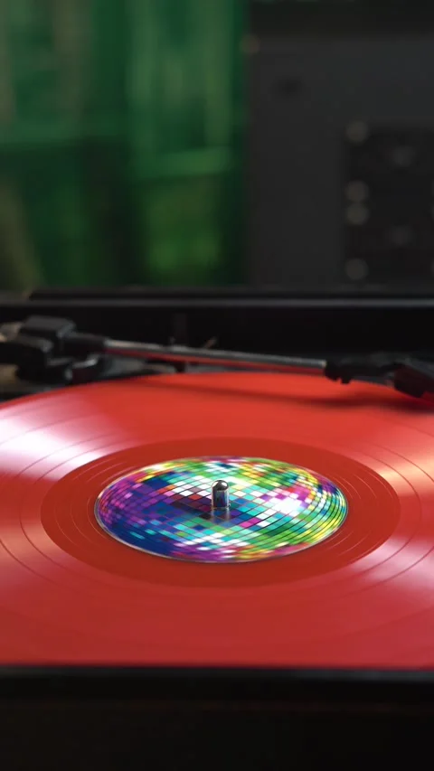 Vertical View of Red Vinyl Record, Placing dn Starting Playback on Turntable in Stock Footage 337563320