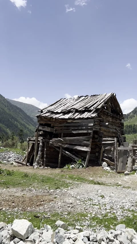 Vertical view of a remote mountain village with rustic wooden huts Stock Footage 329322491