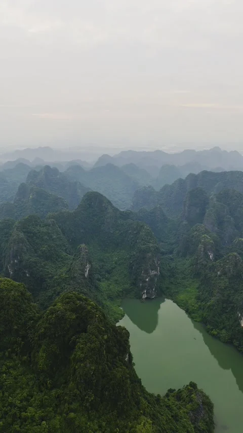 Vertical view of river and limestone mountains in Trang An, Ninh Binh – 4K Stock Footage 325040560