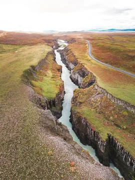 Vertical view of a river running in a canyon, vibrant autumn colors on the hills Foto stock