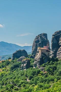 Vertical view of Rousanou Monastery complex built on vertical cliff surroun.. Stock Photos