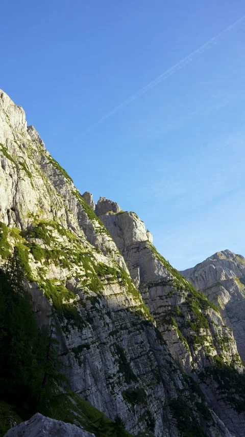 Vertical view of rugged limestone rock faces above Vrata Valley in Triglav Video stock 347037770