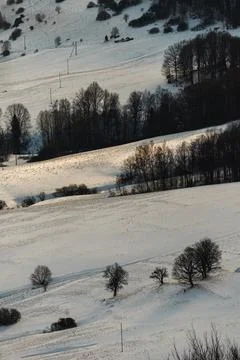 Vertical view of a scenic winter mountain landscape with layered snowy hill.. Stock Photos