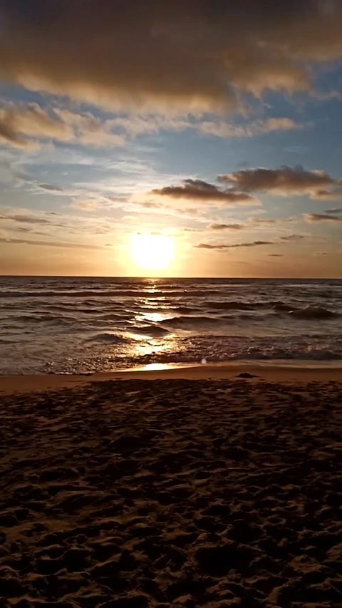 Vertical view of the sea and its waves during sunset, hanheld shot Stock Footage 233599739