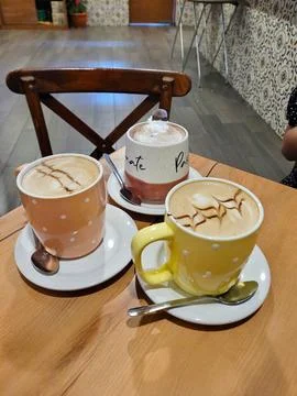 Vertical View of A selection of crafted cappuccinos in Polka Dot Cups Stock Photos
