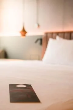Vertical view of selective focus Minimalist Hotel Room With door sign on White B Stock Photos