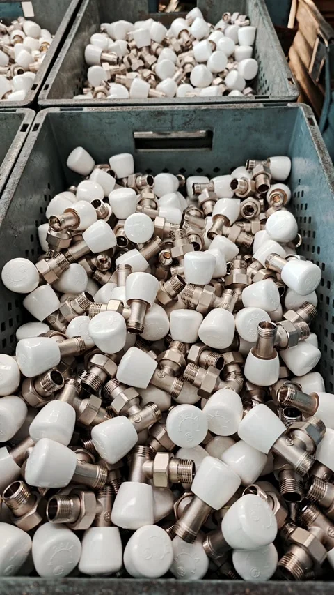 Vertical view of several containers filled with white-capped parts on the Stock Footage 329321726