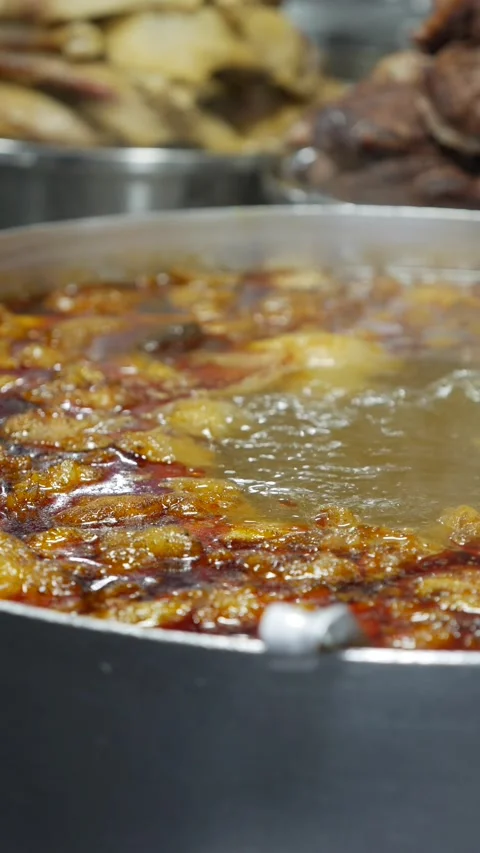 Vertical view shows Bun Mang Vit soup boiling in a large metal pot during Stock Footage 335206275