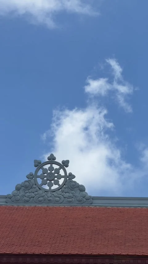 Vertical view shows golden Buddha statue from side seated on pedestal against cl Stock Footage 338001091