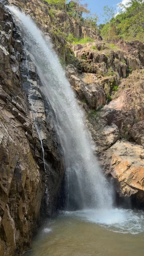 Vertical view shows a waterfall stream d... | Stock Video | Pond5