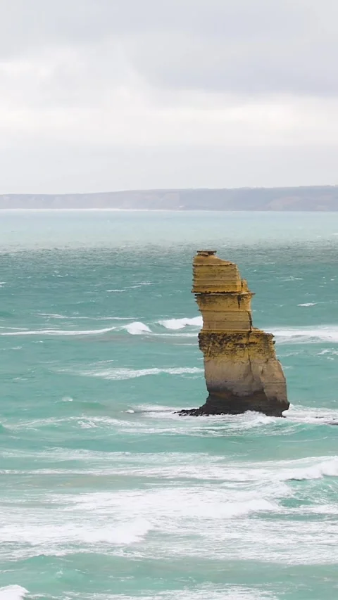 Vertical View of a Single Limestone Sea Stack in Turquoise Ocean Stock Footage 325828227