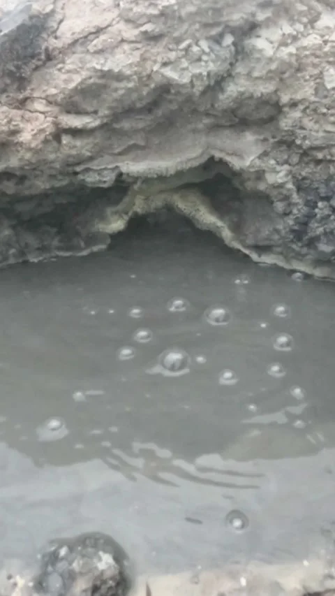 Vertical view Slow motion of boiling mud bubbles and hot steam in the geyser Stock Footage 319921228