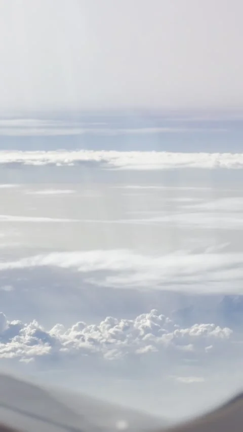Vertical View of Soft White Clouds from Airplane Window Stock Footage 340013262