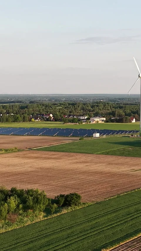 Vertical view. Solar panel and wind turbine installation on farm Stock Footage 348631261