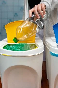 Vertical view of sorting plastic bottle into trash can 写真素材