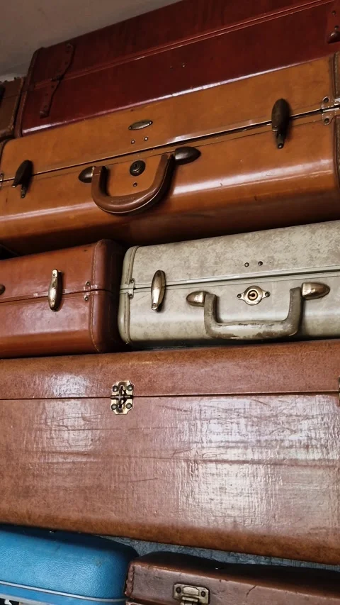 Vertical View, Stack of Vintage Suitcases, Different Sizes and Colors Stock Footage 346663454