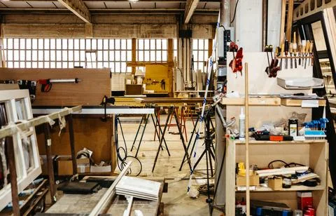Vertical view of stacked metal window frames in carpentry workshop Stock-Fotos