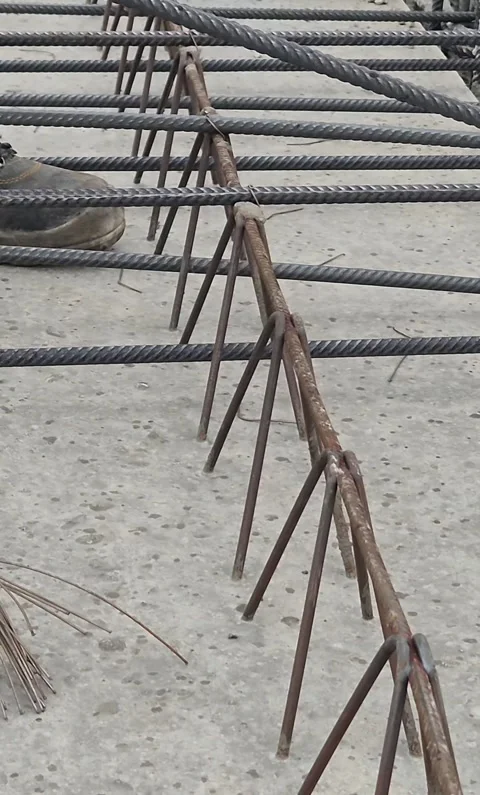 Vertical View of Steel Fixer Working on Concrete Slab Reinforcement Stock Footage 333984257