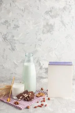 Vertical view of stick shaped candy in glass cup bottle filled with milk an.. Stock Photos