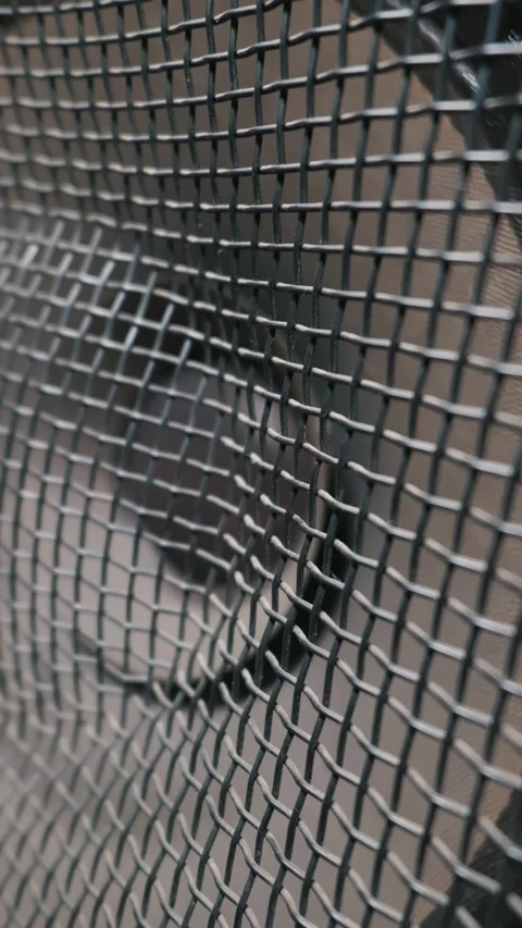 Vertical View of Subwoofer Cone Moving Heavily Behind Metal Protective Grille Stock Footage 333827277
