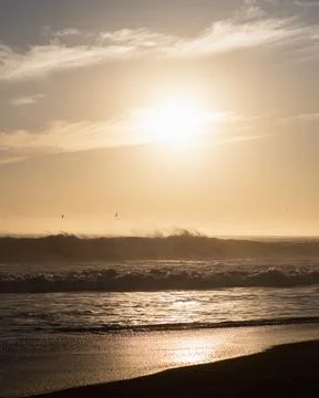 Vertical view of sunset on the beach in front of the sun Stock Photos